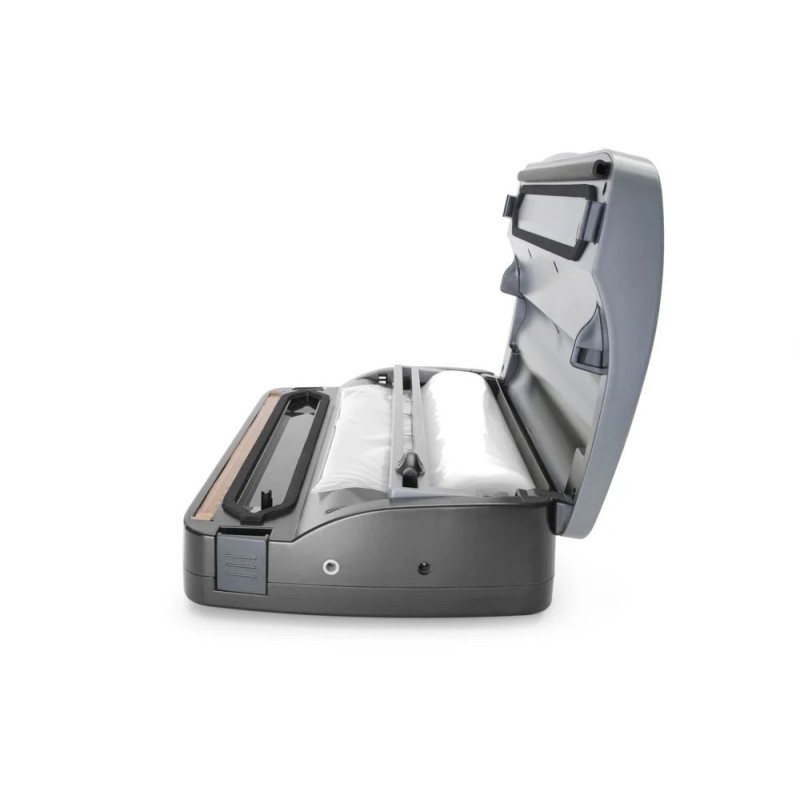 Strip vacuum packaging machine with roll feeder
